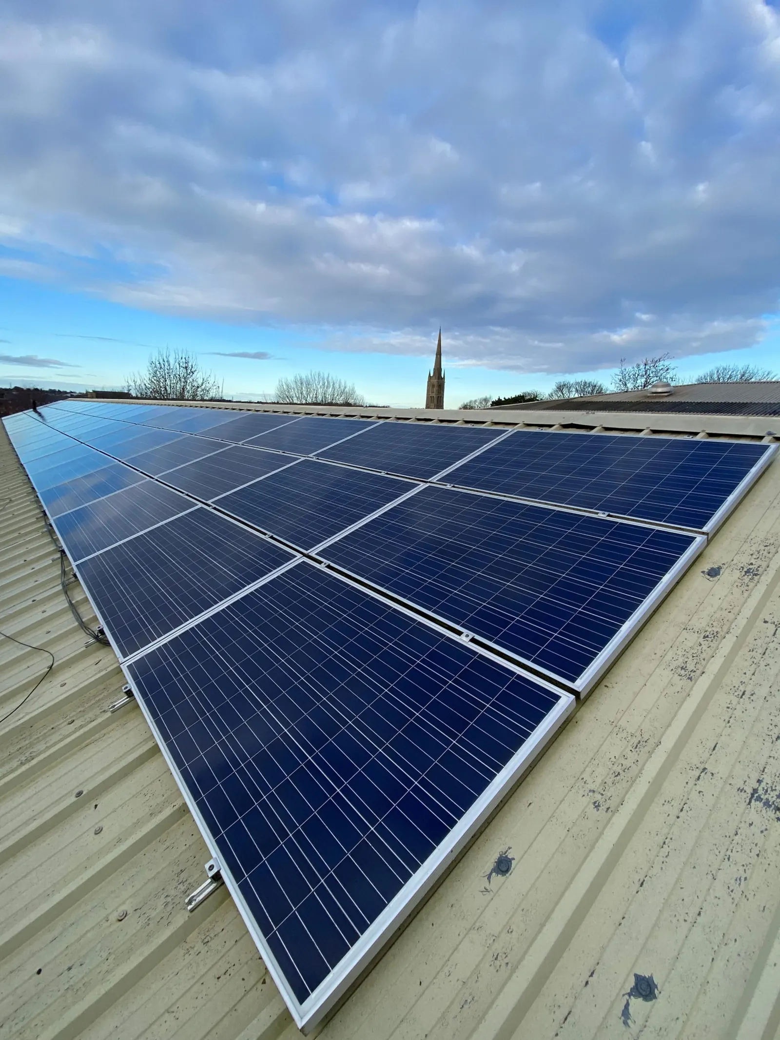 Solar panels on a commercial roof being cleaned by Lanes Ltd